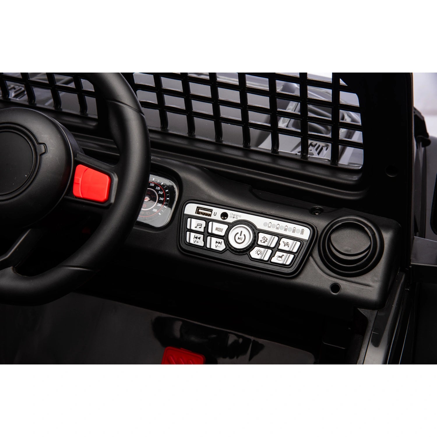 Close-up of dashboard controls, steering wheel, and black interior panel of 12V black Jeep style ride-on toy car for kids