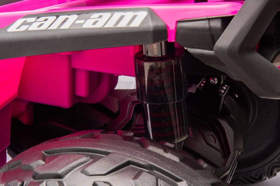 Close-up of rear suspension and textured tire on Barbie pink 24V Can-Am Outlander Monster 2-Seater ride-on quad.