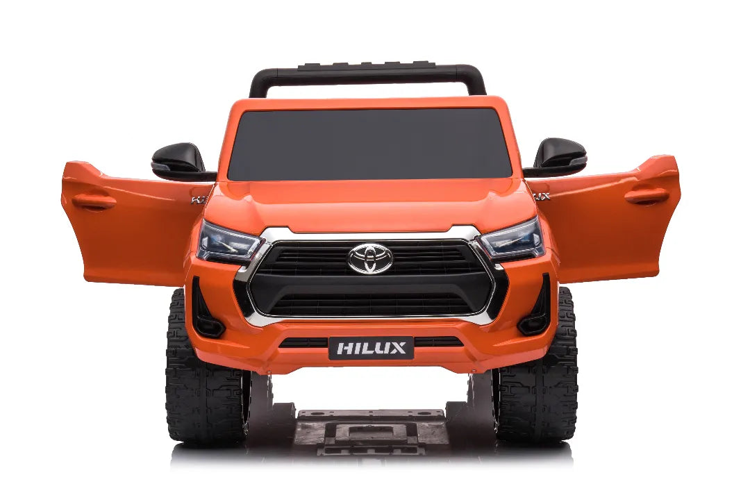 Front view of orange 24V licensed Toyota Hilux SR5 kids ride-on ute with open doors and black side mirrors