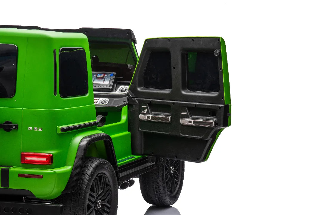 Rear view of green 24V 14Ah licensed Mercedes-AMG G63 kids ride-on car with open rear door and black wheels