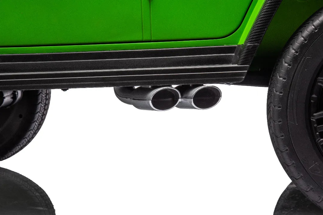 Close-up of dual chrome exhaust pipes and black running board on green 24V Mercedes-AMG G63 kids ride-on car.