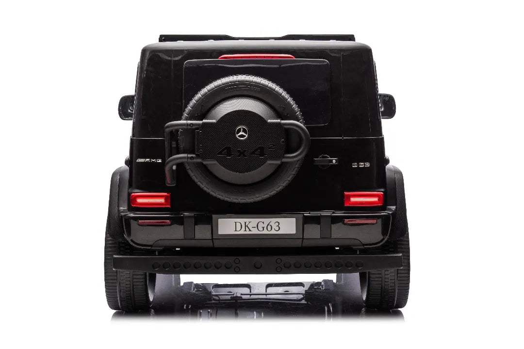 Rear view of black 24V 14Ah licensed Mercedes-AMG G63 kids ride-on car with spare wheel and 4x4 branding