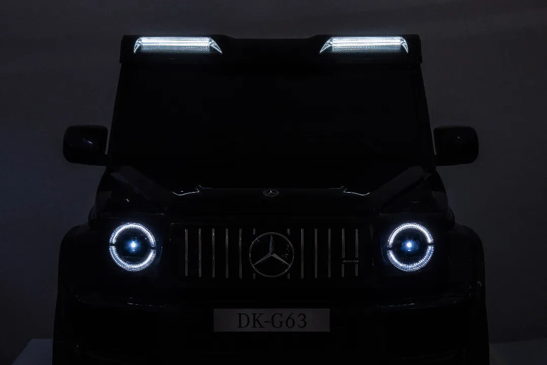 Front view of black 24V 14Ah Mercedes-AMG G63 kids ride-on car with illuminated headlights and roof lights