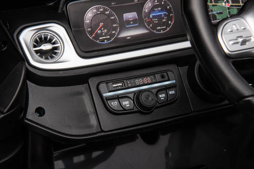 Close-up of dashboard control panel with USB port and buttons inside 24V Mercedes-AMG G63 kids ride-on car