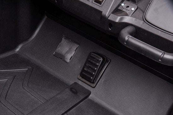 Close-up of the foot pedals inside the Stinger Buggy XL 24V 4x4 kids ride-on car in gold.