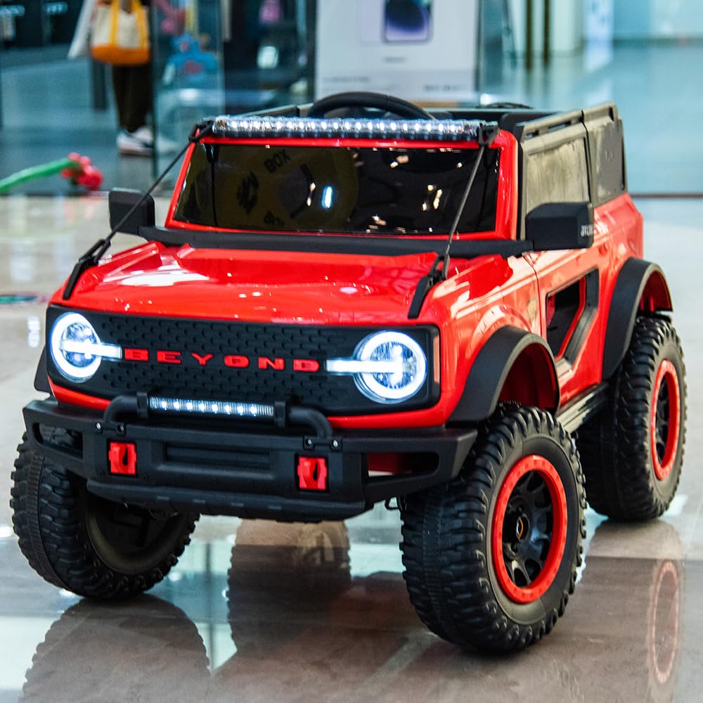 Red Ride-On Jeep Beyond 12V 4WD UTV for kids with remote control, headlights, and rugged tires indoors.