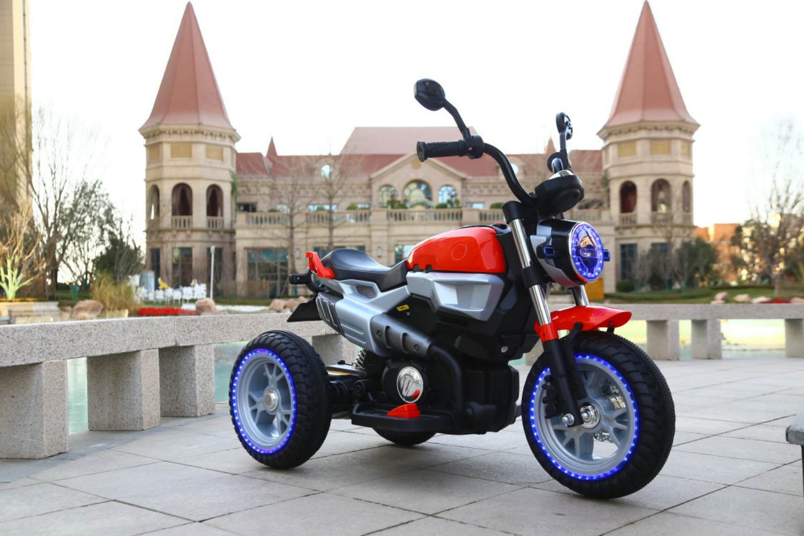 12V battery-powered kids motorcycle with LED lights and stable three-wheel design for children aged 3 to 7 years.