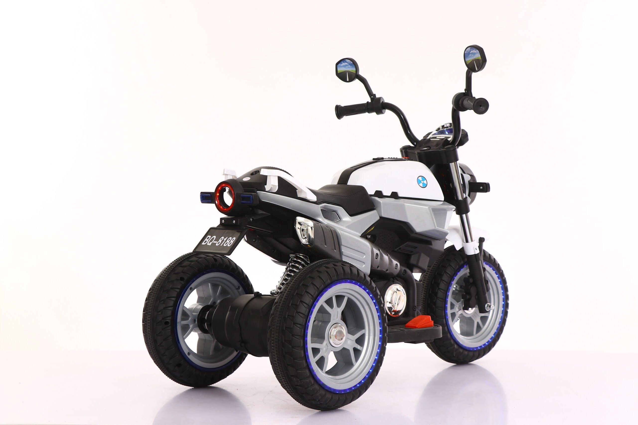Grey 12V electric ride-on motorbike for kids aged 3 to 7 with LED lights and manual pedal control.