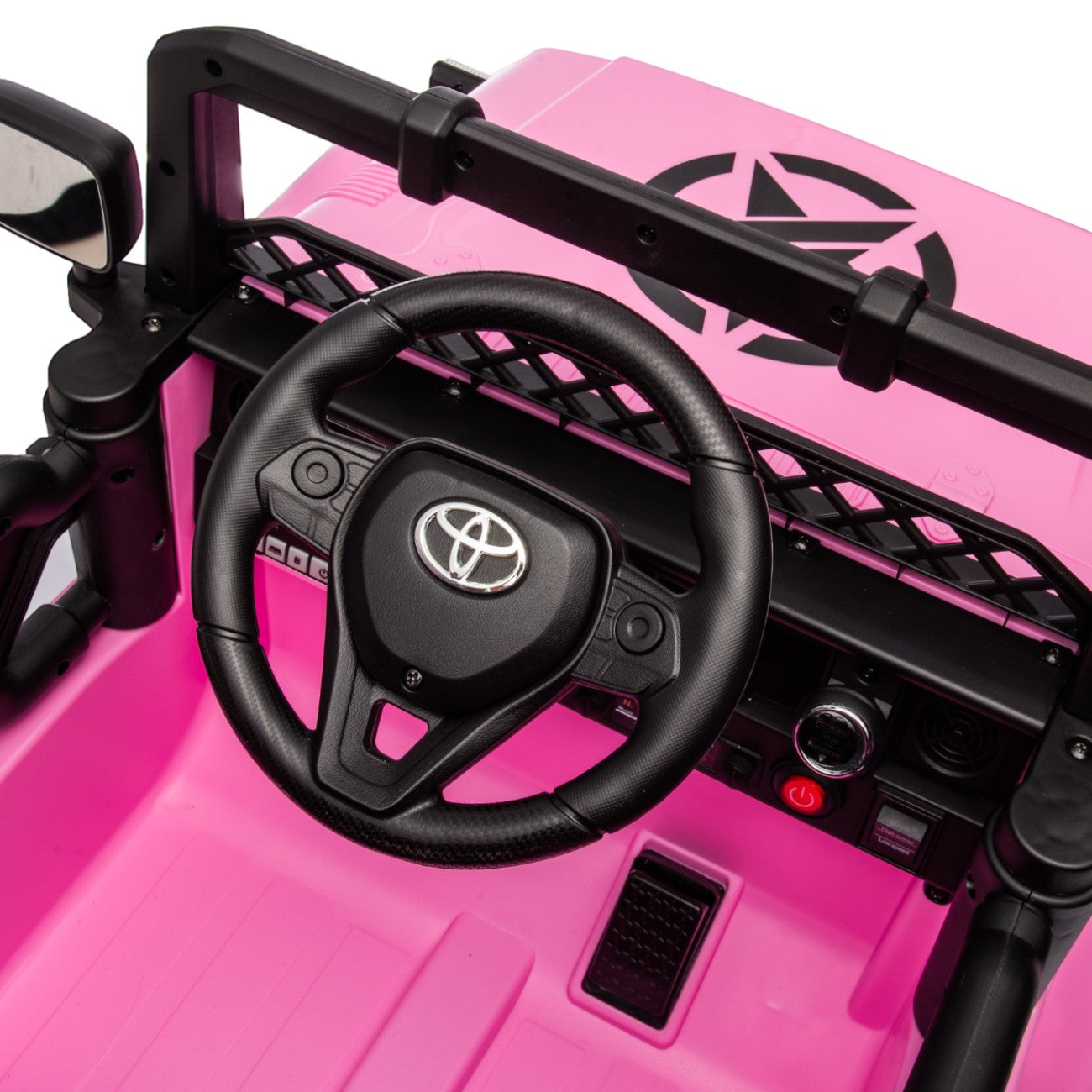 Close-up of pink Toyota FJ Cruiser licensed electric toy car steering wheel and dashboard for kids ride-on vehicle