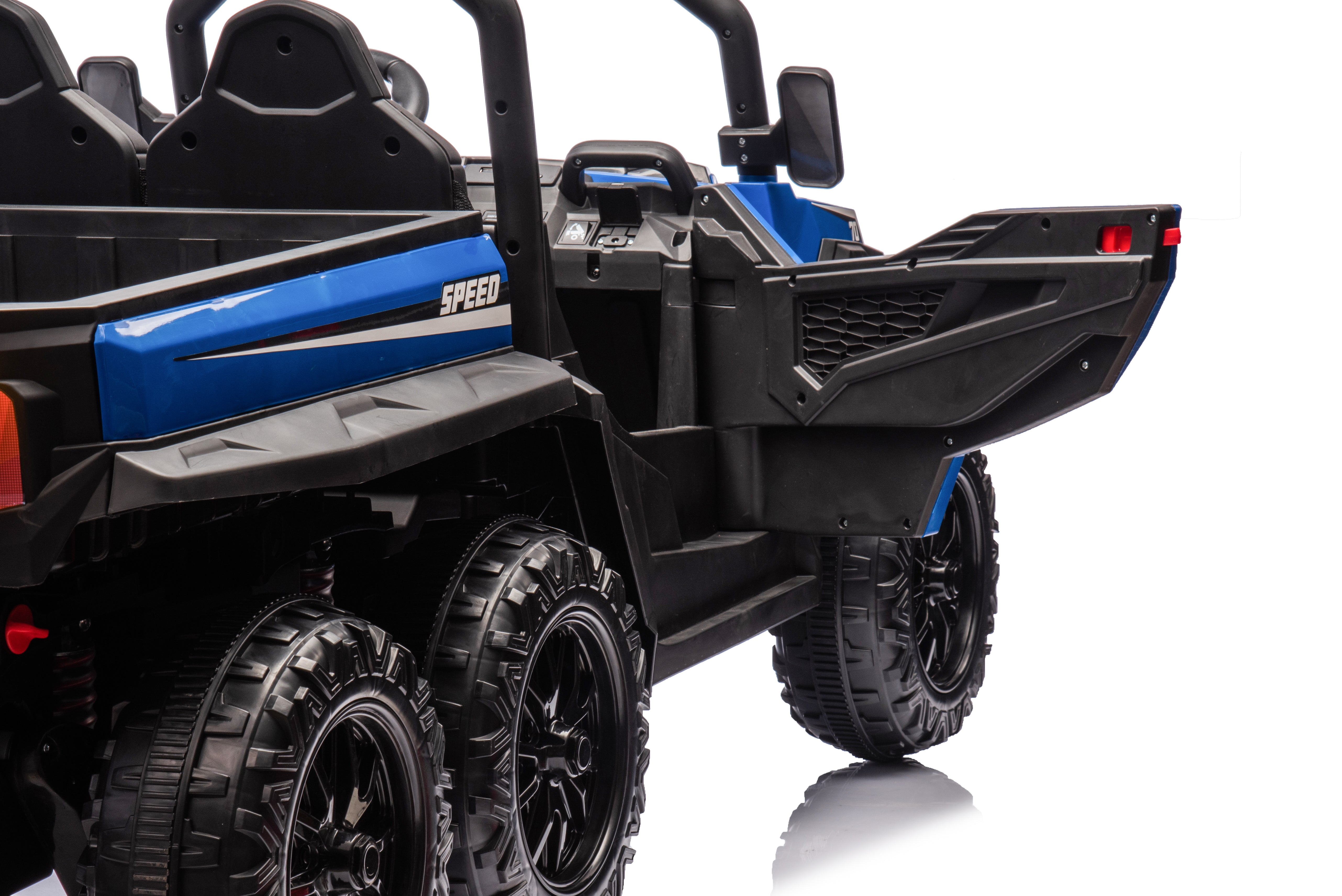 Close-up of blue 24V electric ride-on dump truck with six black EVA wheels and working tipper cargo bed.