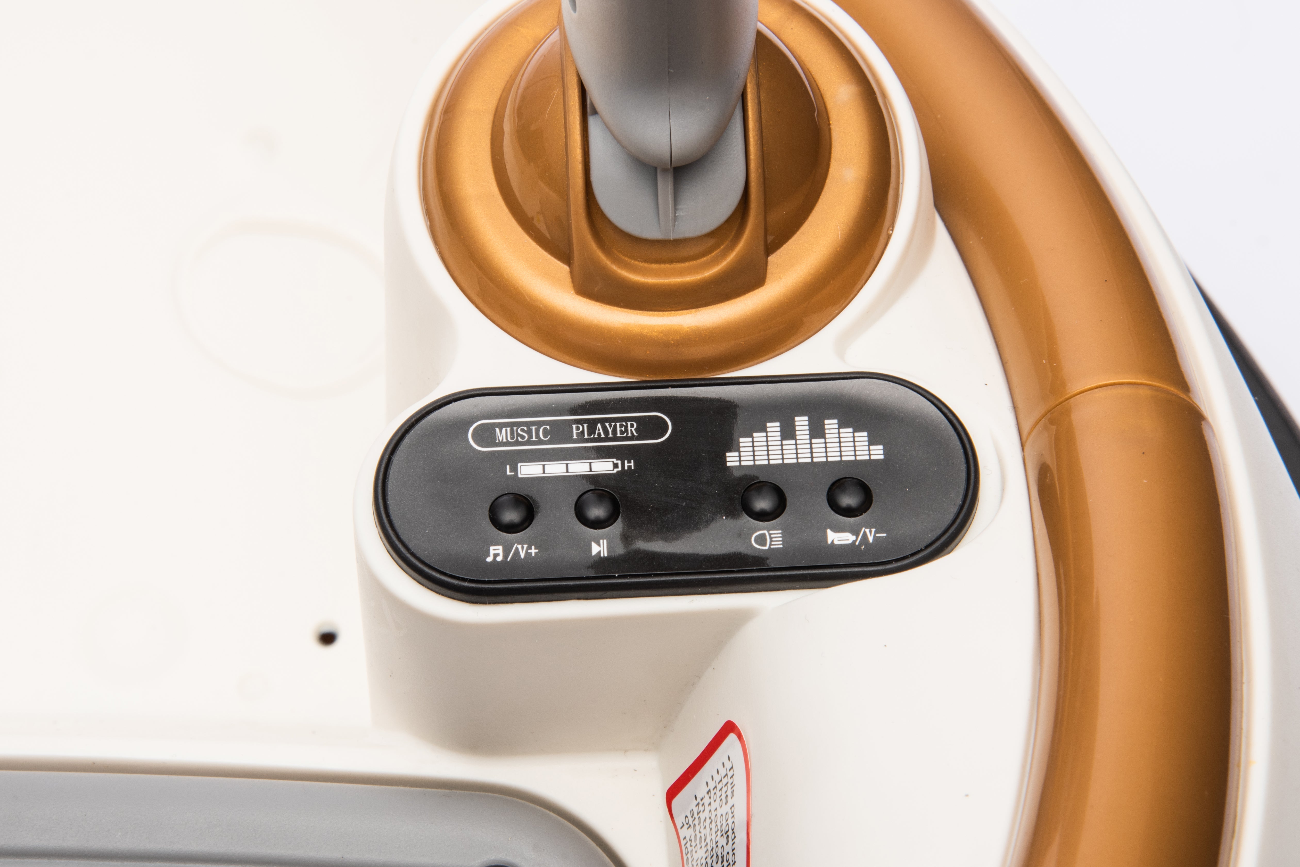 Close-up of the music player control panel on a champagne 12V kids bumper car ride-on toy.