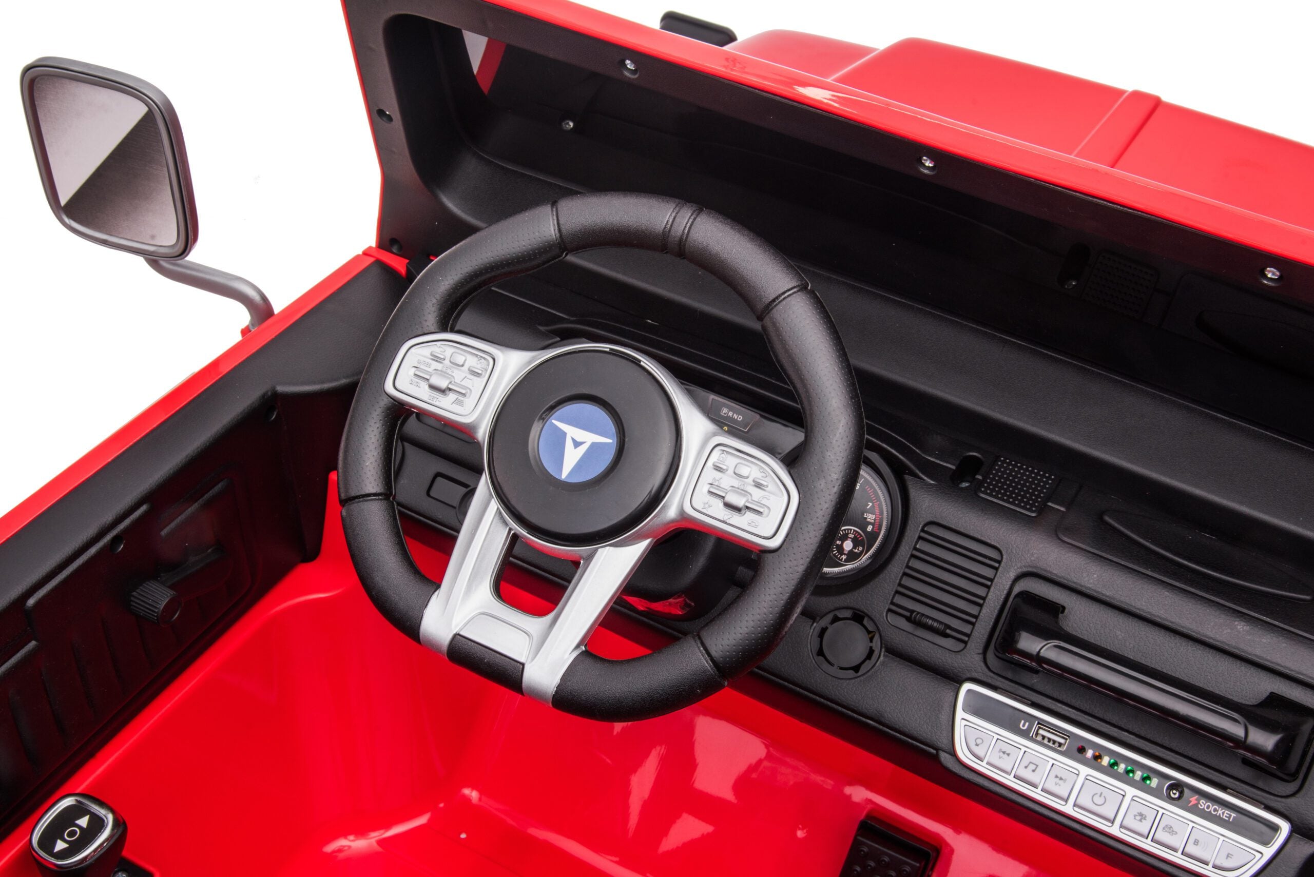 Close-up of the red 24V Toyota FJ-40 kids ride-on car interior showing steering wheel and dashboard details.