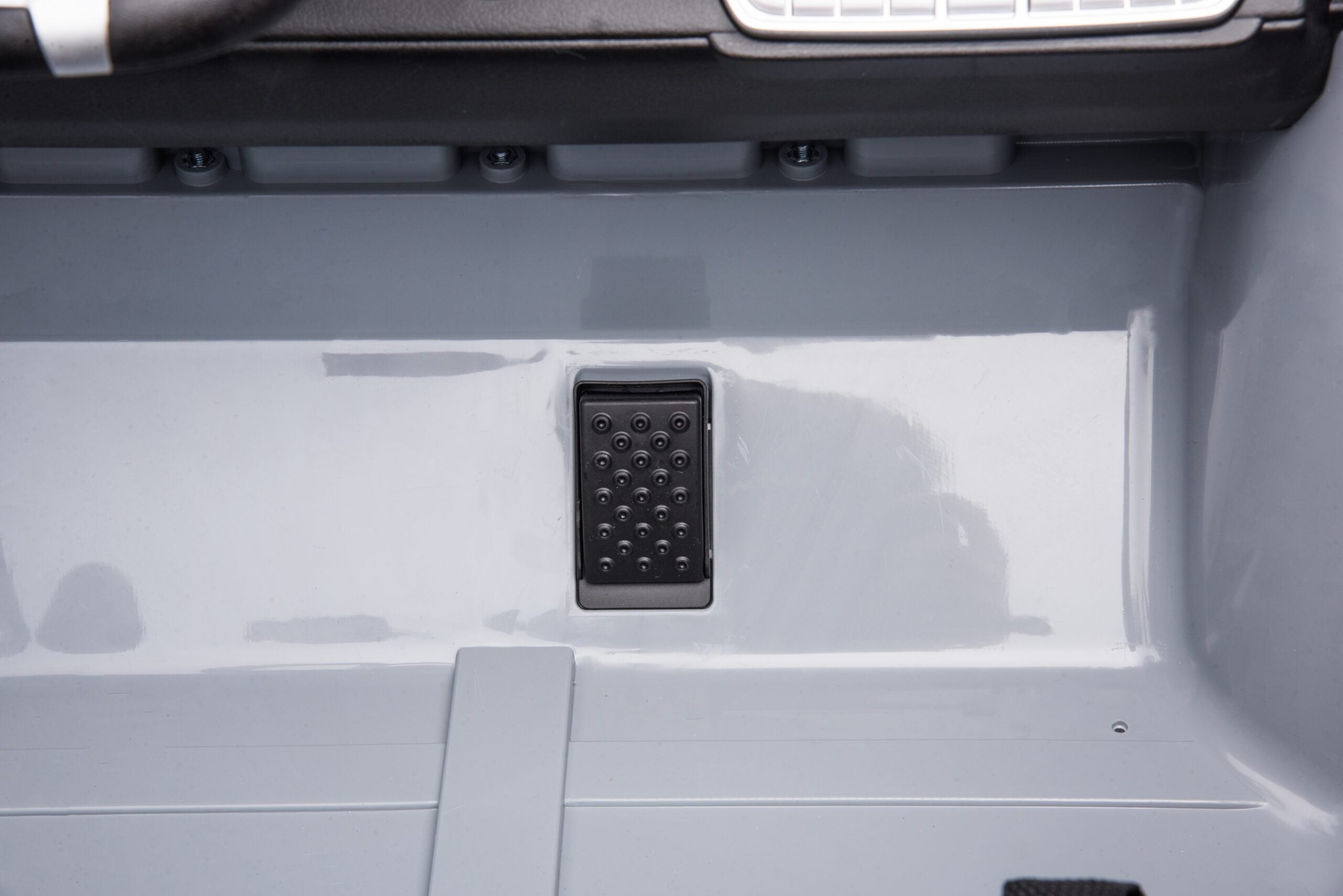 Close-up of the accelerator pedal inside the black 24V 4WD Toyota FJ-40 kids electric ride-on car