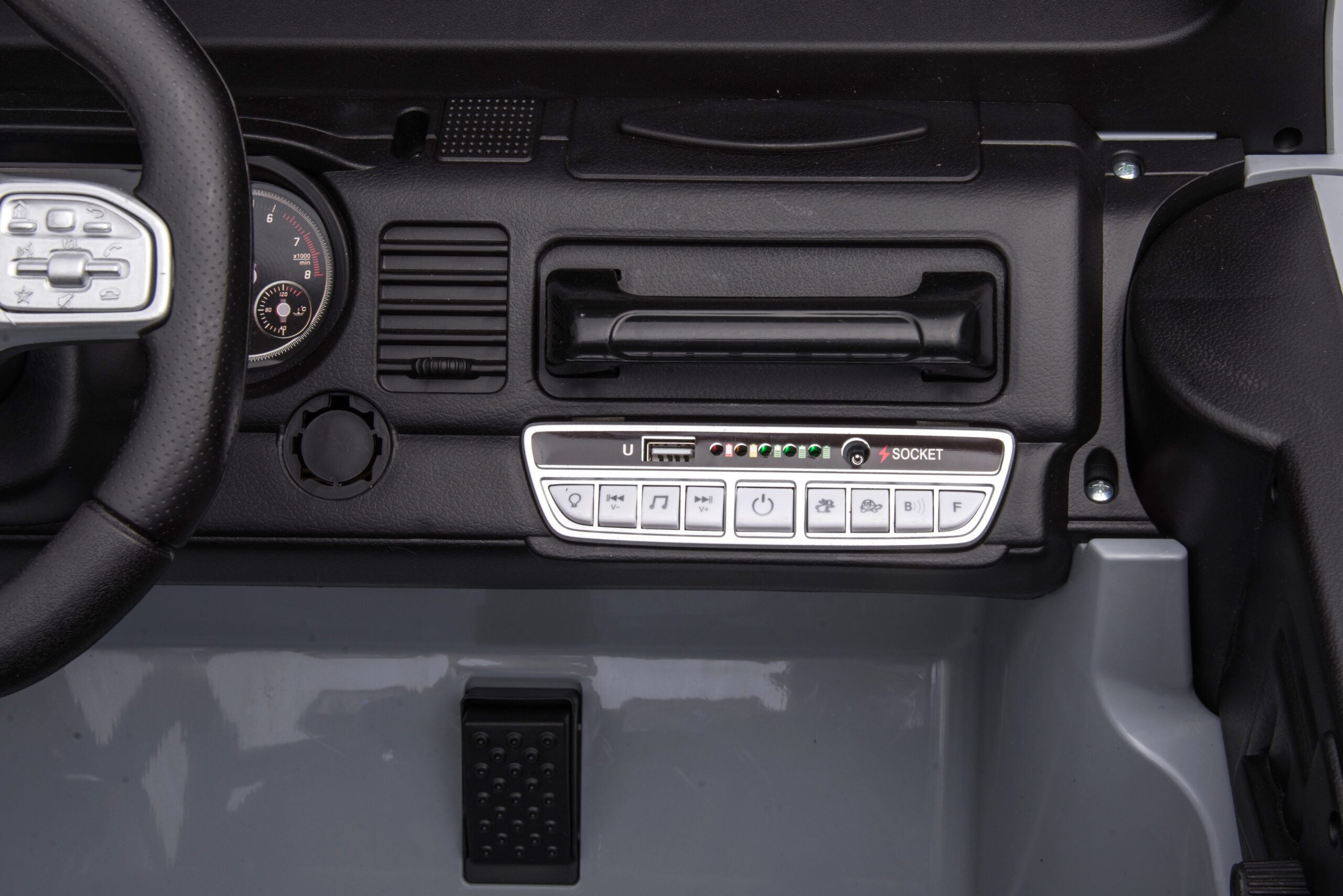 Dashboard control panel with buttons, USB port, and socket inside a black 24V Toyota FJ-40 kids electric ride-on car