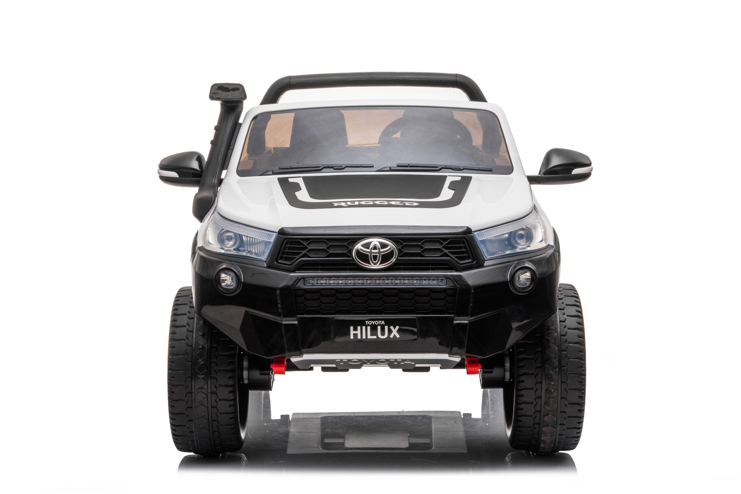Front view of white 24V ride-on Toyota Hilux 4WD electric kids car with realistic details and large wheels.