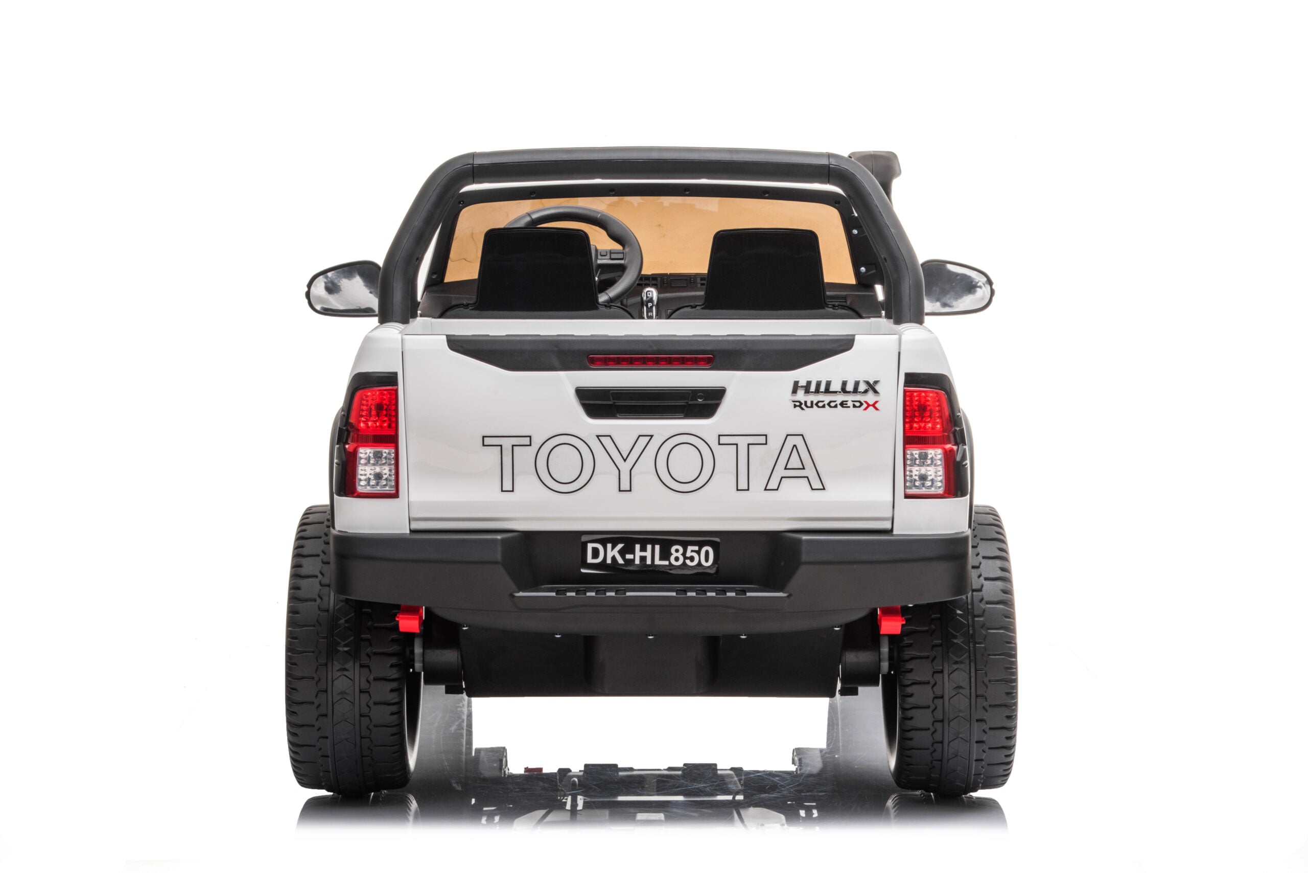Rear view of white 24V Toyota Hilux 4WD ride-on electric car with realistic details and twin seats for kids.