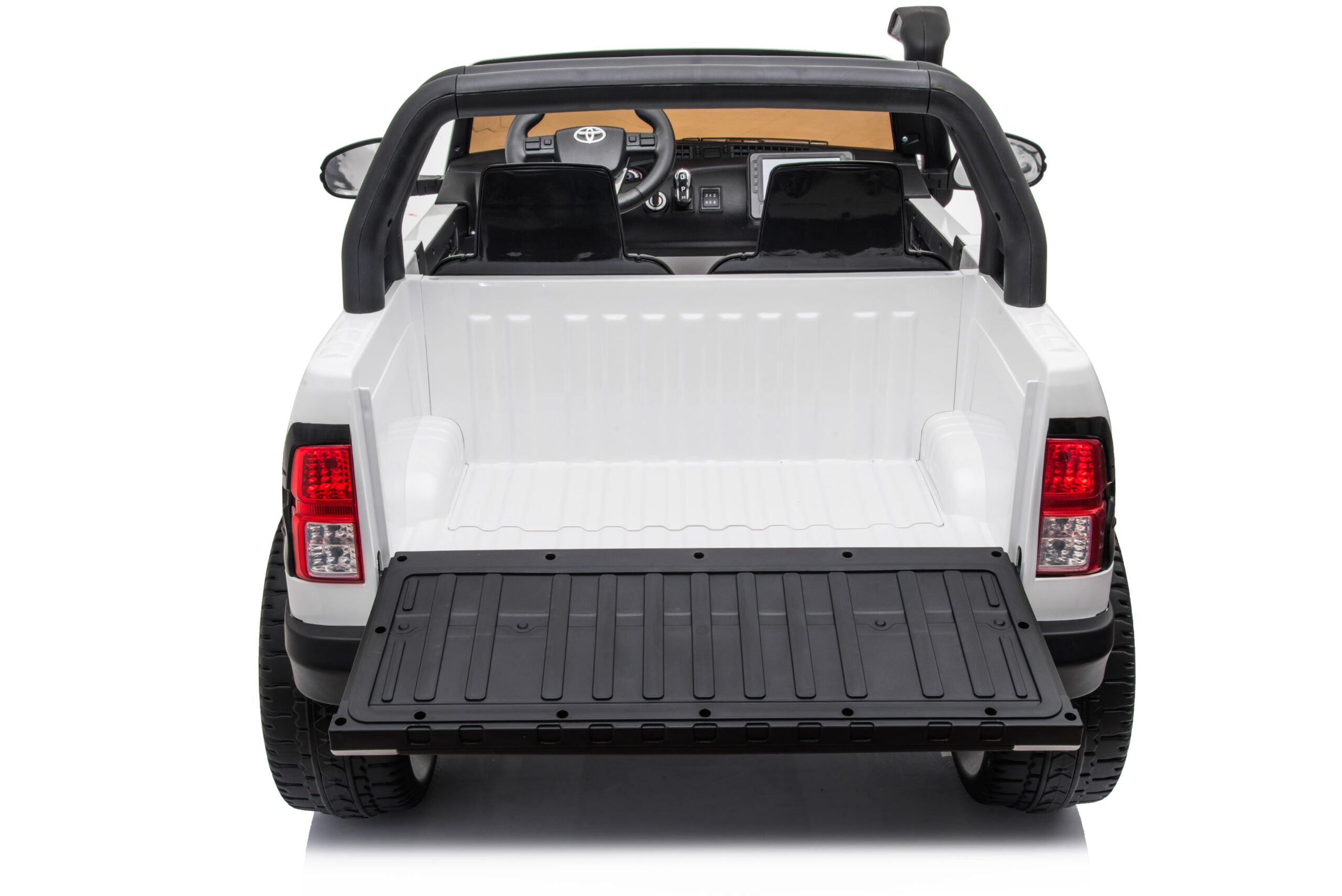 Rear view of white 24V Toyota Hilux 4WD ride-on toy car with open tailgate and realistic details