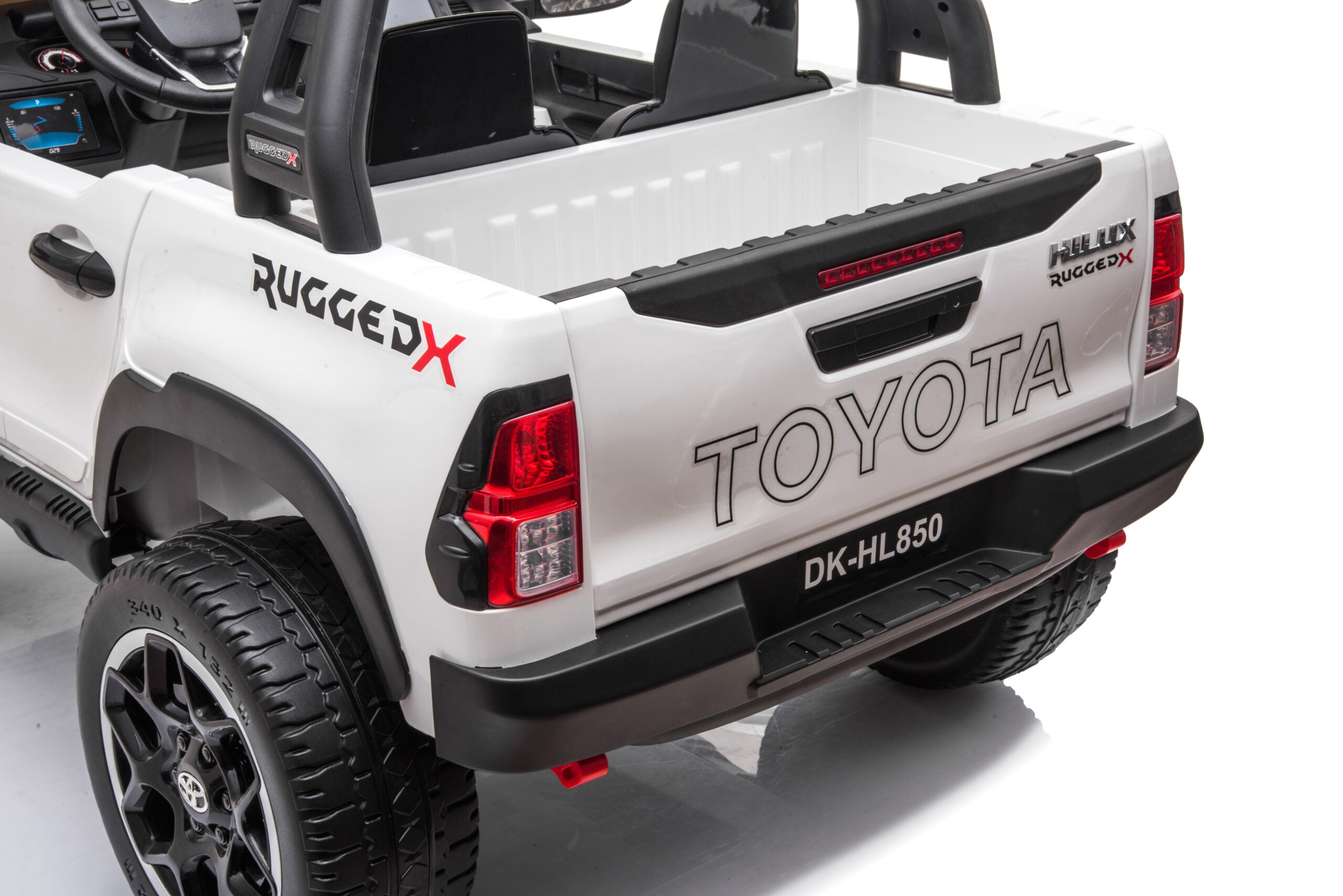 Rear view of white 24v Toyota Hilux 4WD ride-on toy car with rugged design and realistic details