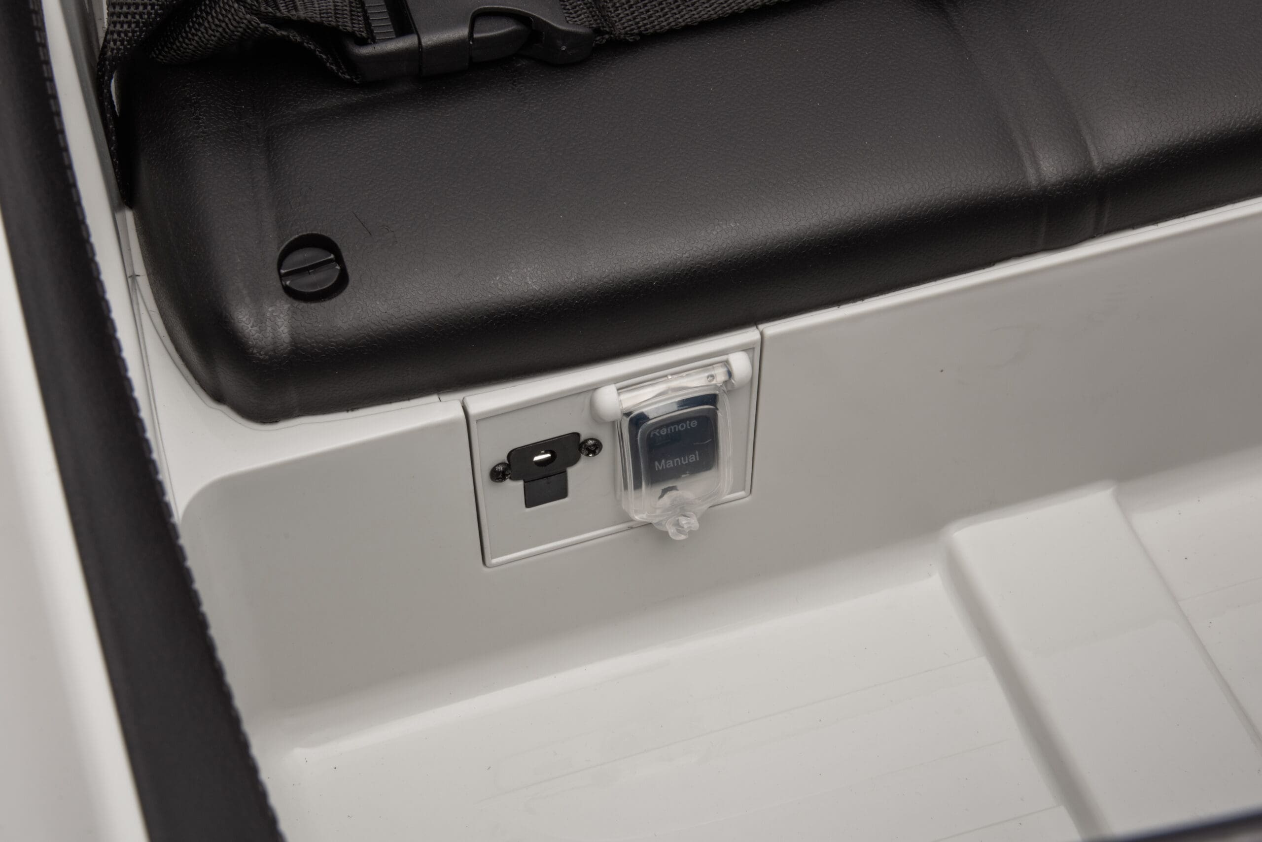 Close-up of the white Mercedes kids ride-on car’s USB and AUX ports inside the passenger seat area.