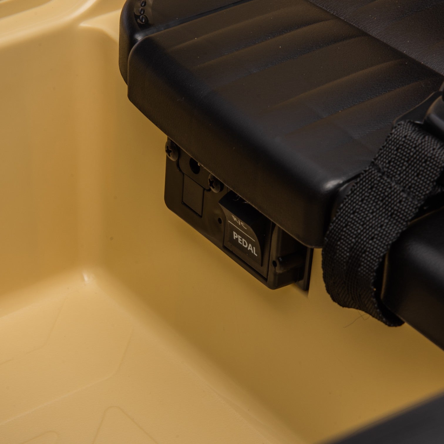 Close-up of the black pedal control inside the beige Toyota FJ Cruiser 12v electric ride-on toy car seat.