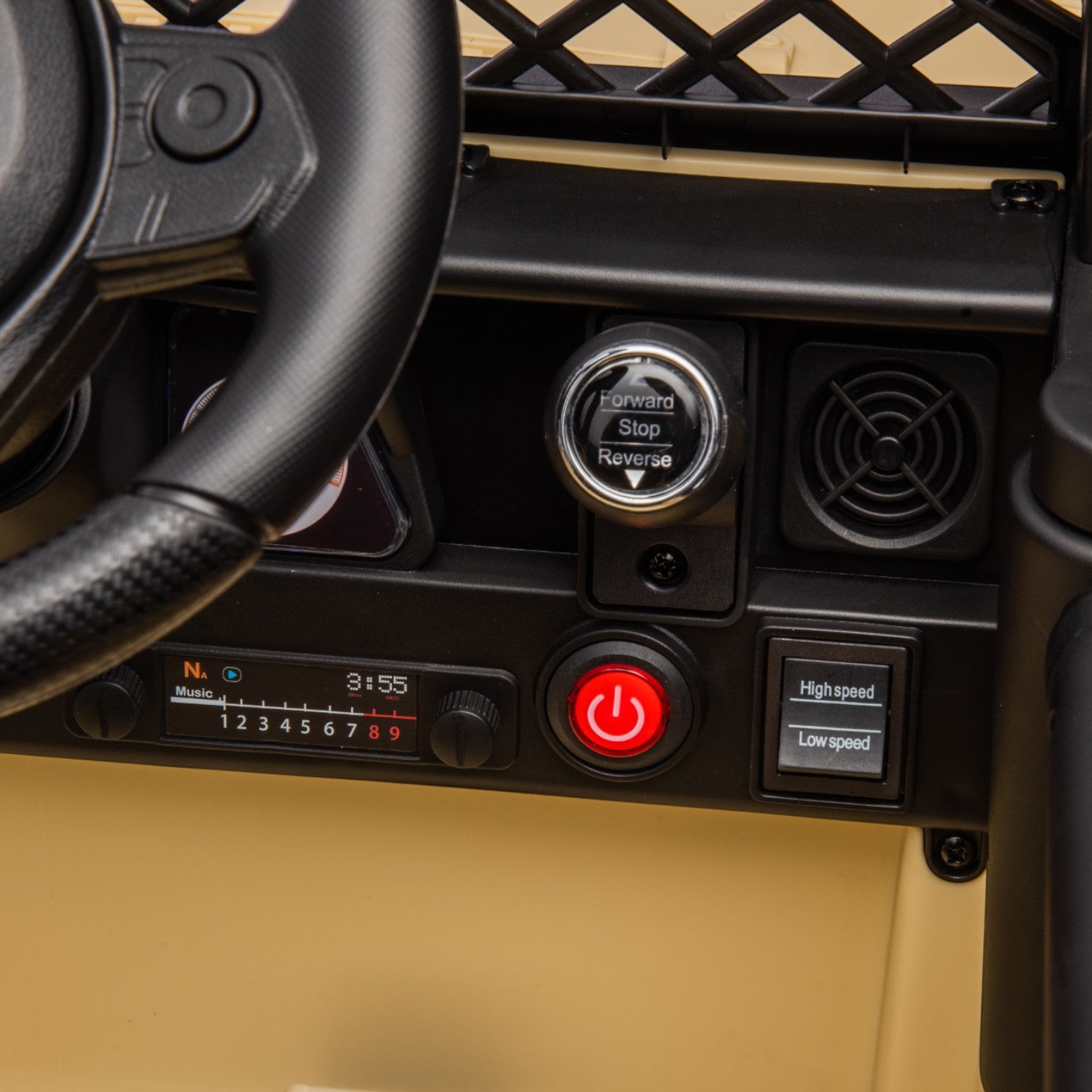 Close-up of the control panel showing steering wheel, forward-reverse switch, power button, and speed selector on a toy car.