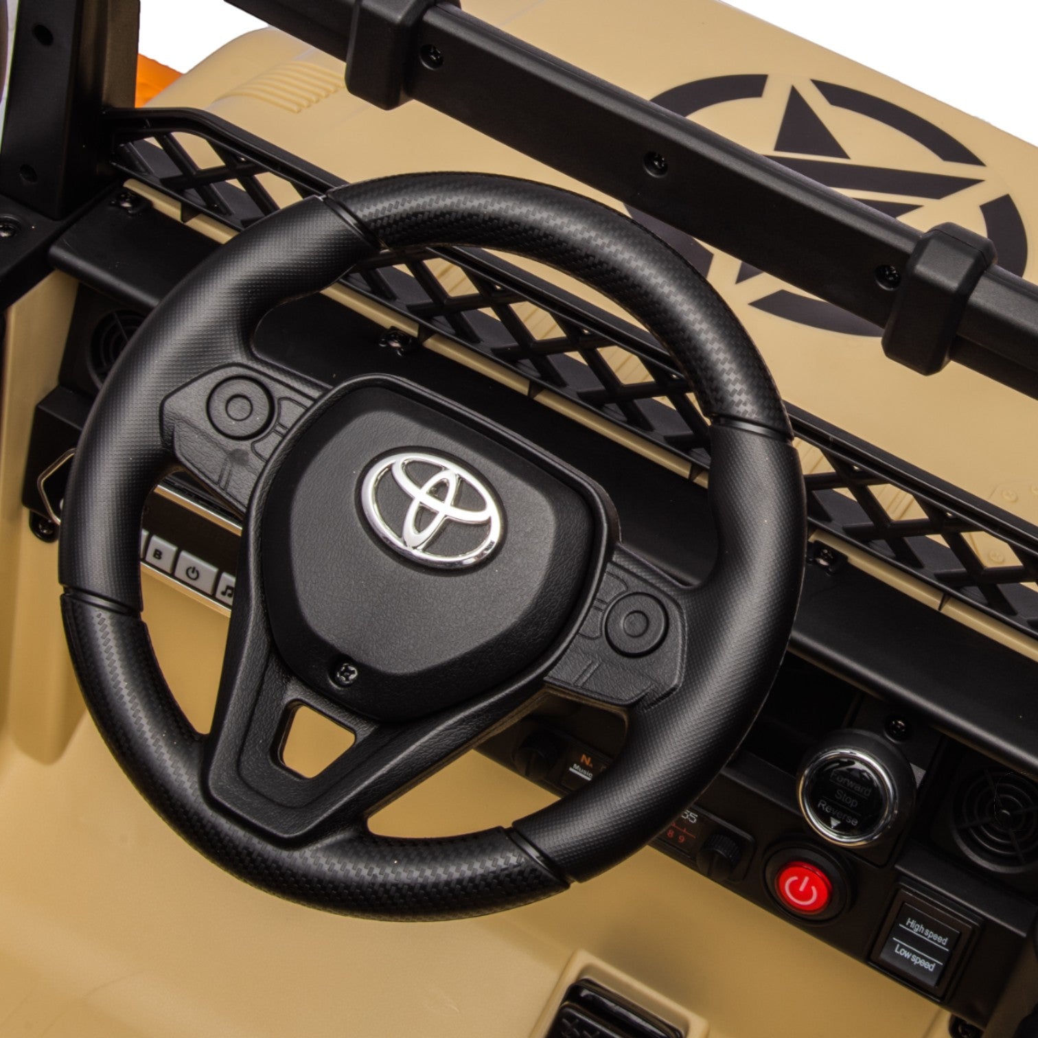 Close-up of the black Toyota FJ Cruiser electric toy car steering wheel with control buttons and dashboard details.