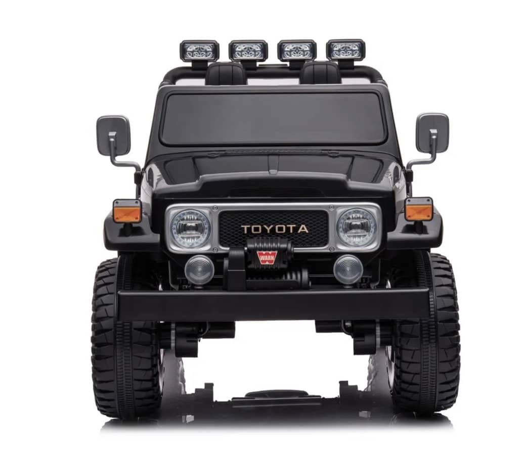 Front view of a black 24V 4WD licensed Toyota FJ-40 kids ride-on electric toy car with headlights and off-road tires.