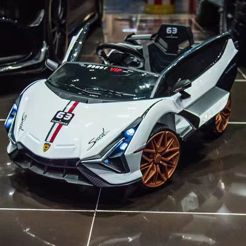 White 12V Lamborghini inspired ride-on race car for kids with gold wheels and detailed design, suitable for ages 1 and up.