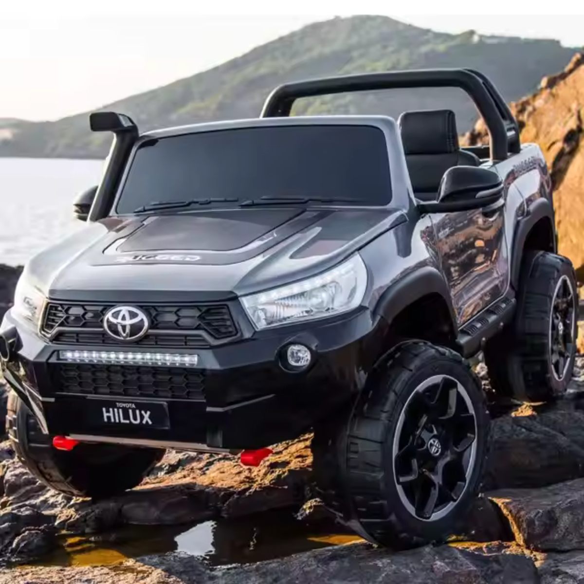 24V Ride-On Toyota Hilux 4WD kids car with spray-painted grey finish, LED lights, and rugged off-road tires.