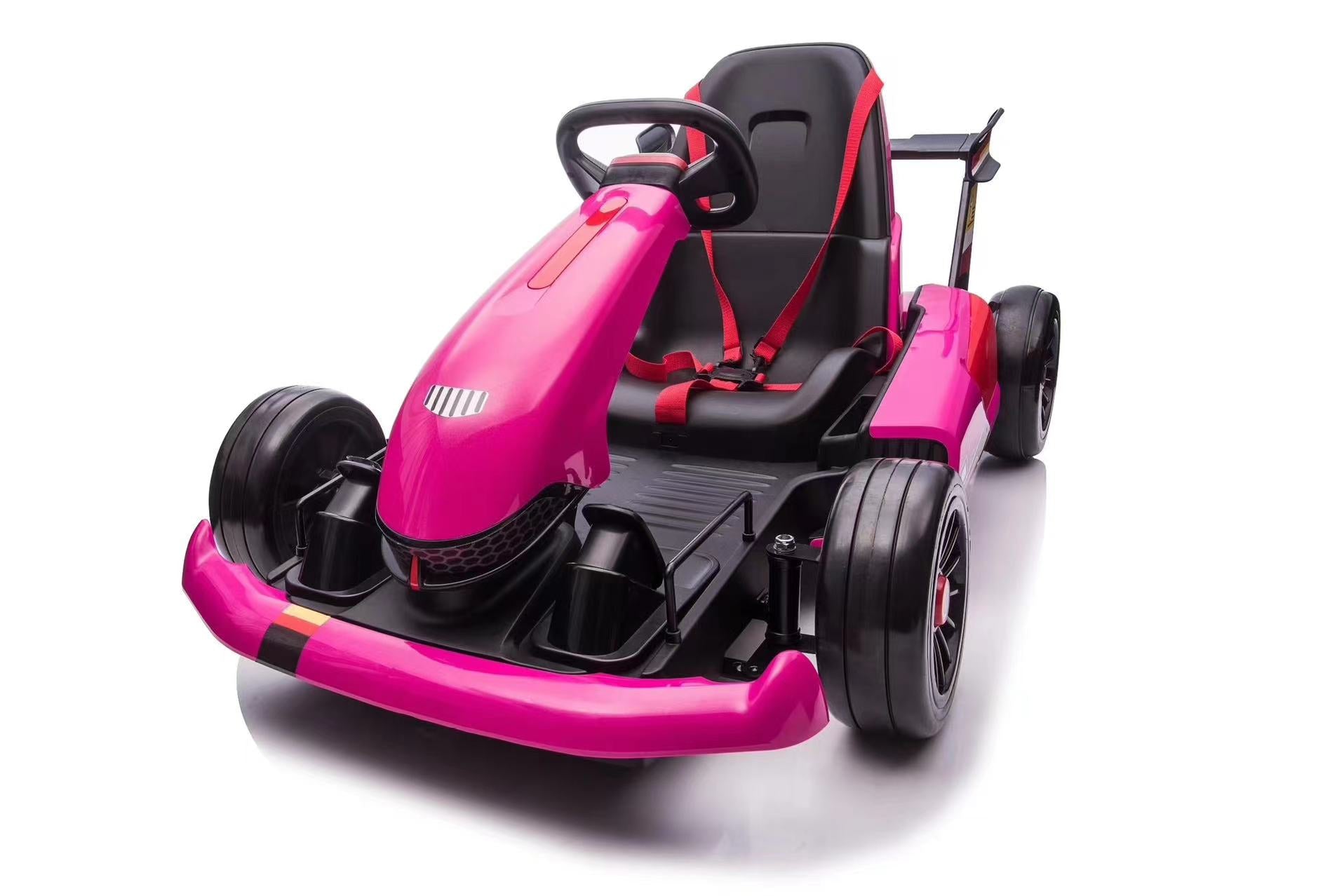 Pink 24V electric go-kart for kids with black seat, red safety harness, and drift function motors visible