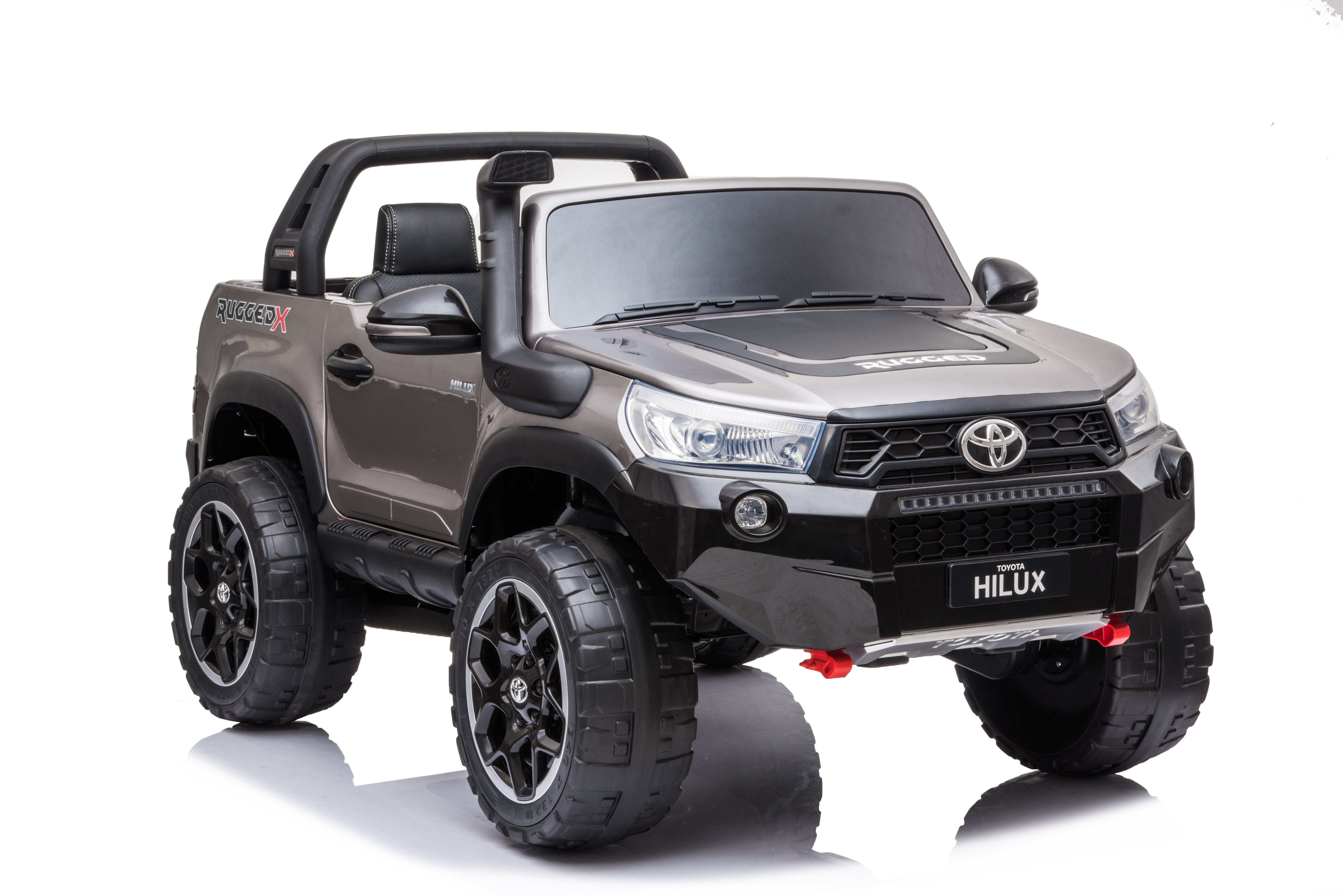 Spray painted grey 24V Toyota Hilux 4WD ride-on car for kids with realistic design and off-road features.