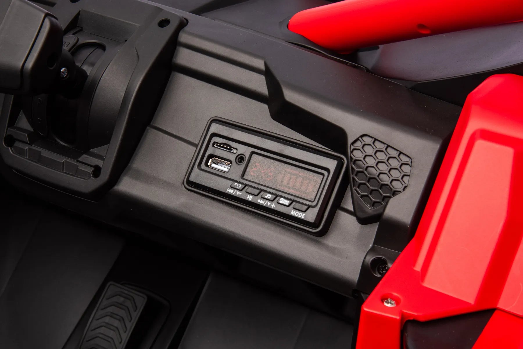 Close-up of control panel with USB ports and digital display on red King of UTVs ZForce RZR Turbo 24V kids buggy.