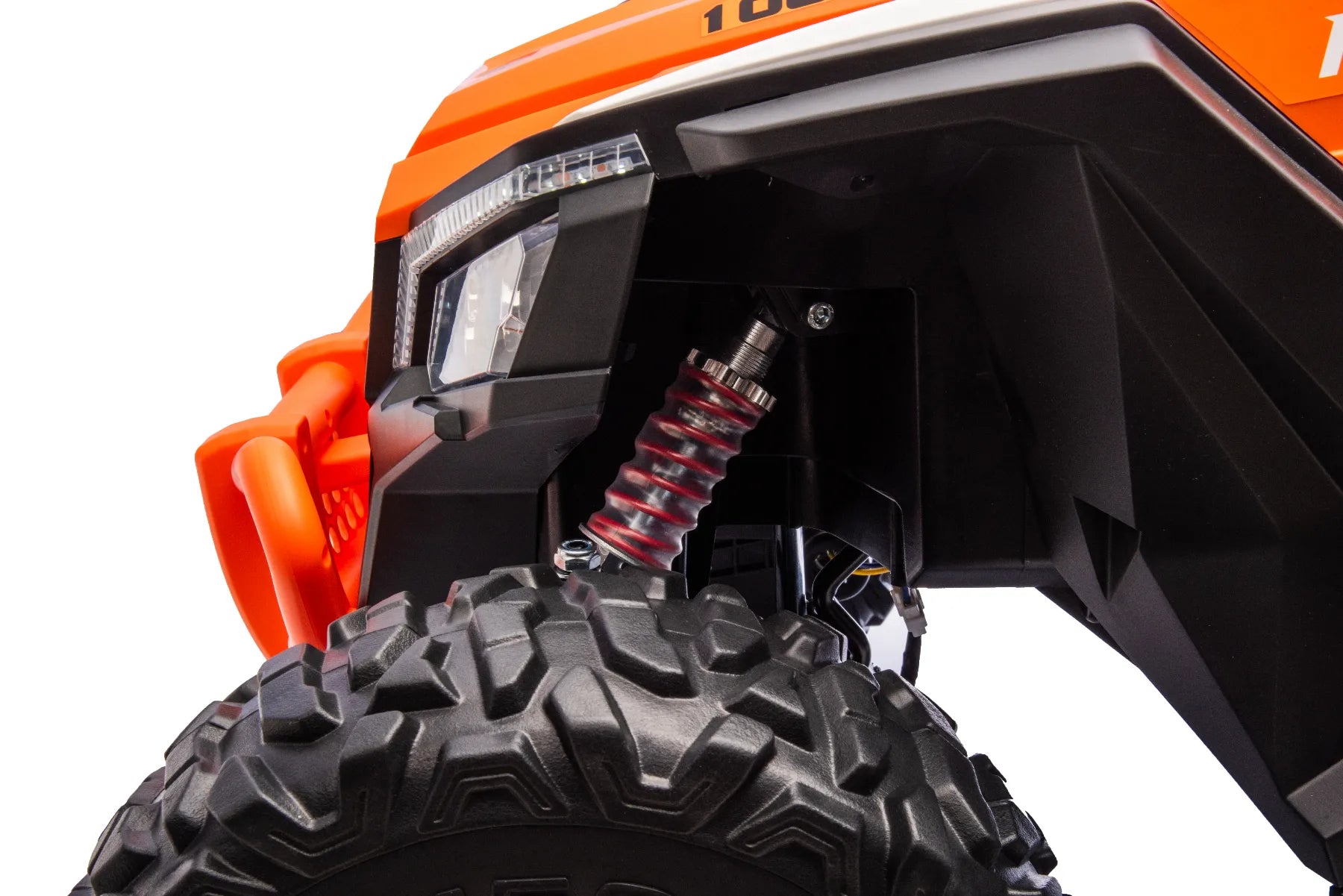 Close-up of front wheel and red suspension coil on orange King of UTVs ZForce RZR Turbo 24V 1400W ride-on buggy