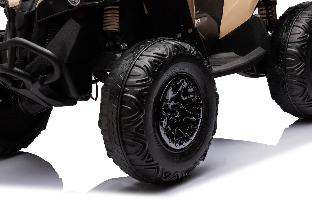Close-up of black aggressive tread tires and black rims on khaki 24V 800W licensed Can-Am Renegade 4x4 kids ATV bike