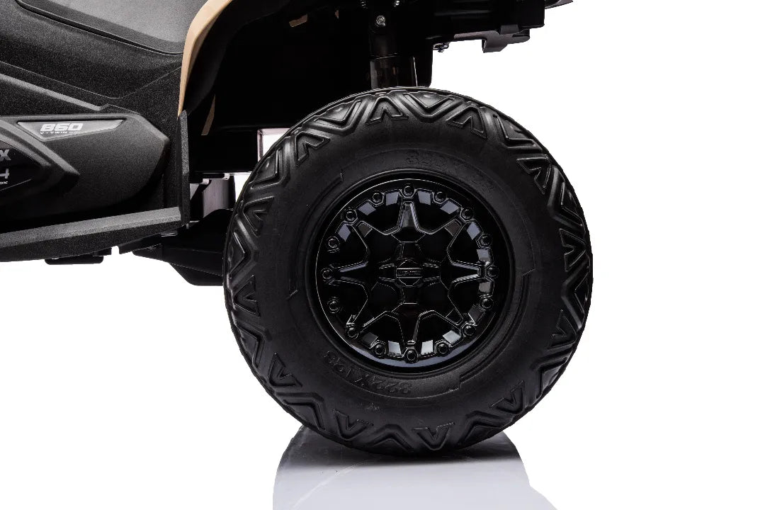 Close-up of black rugged tire and black alloy wheel on khaki 24V 800W Can-Am Renegade 4x4 kids quad bike