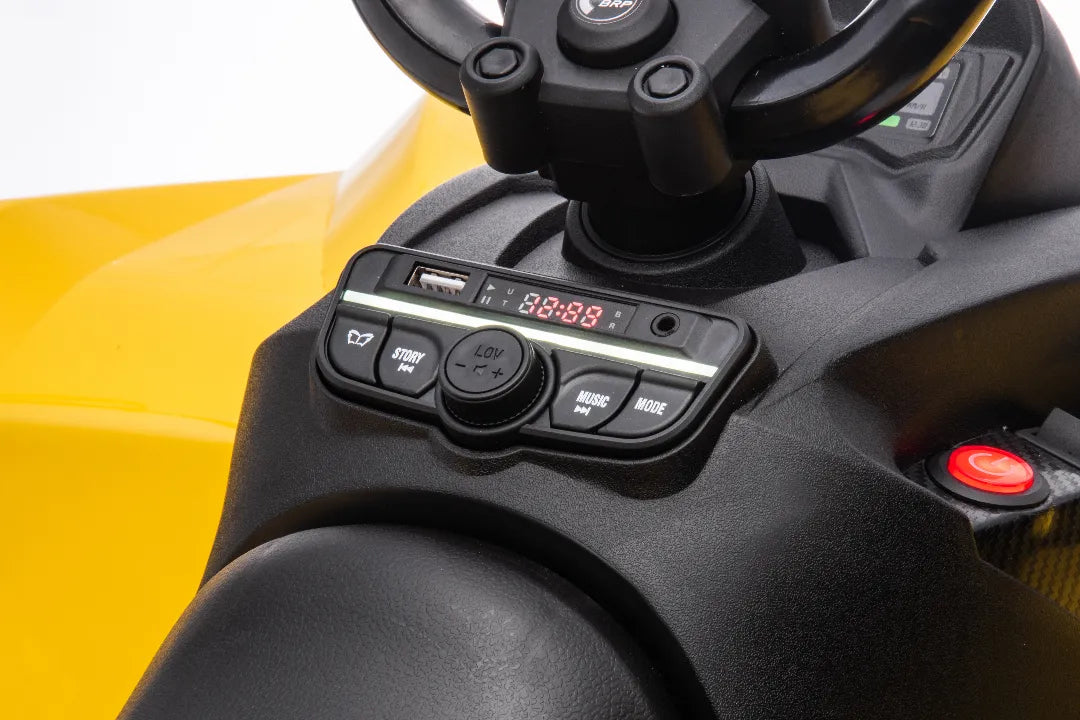 Close-up of control panel with USB port and buttons on yellow 24V Can-Am Renegade ride-on ATV quad bike