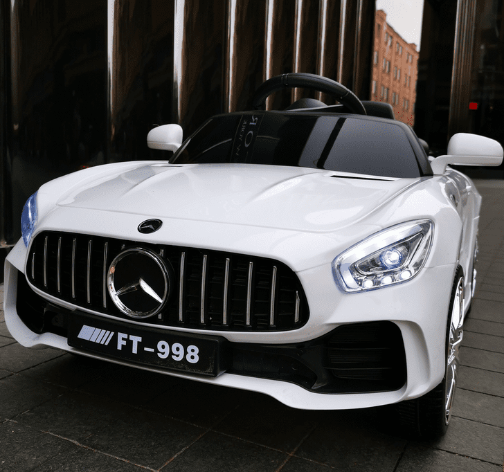White 12V Mercedes AMG inspired kids ride-on car with LED lights and realistic design for ages 3 to 6 years.