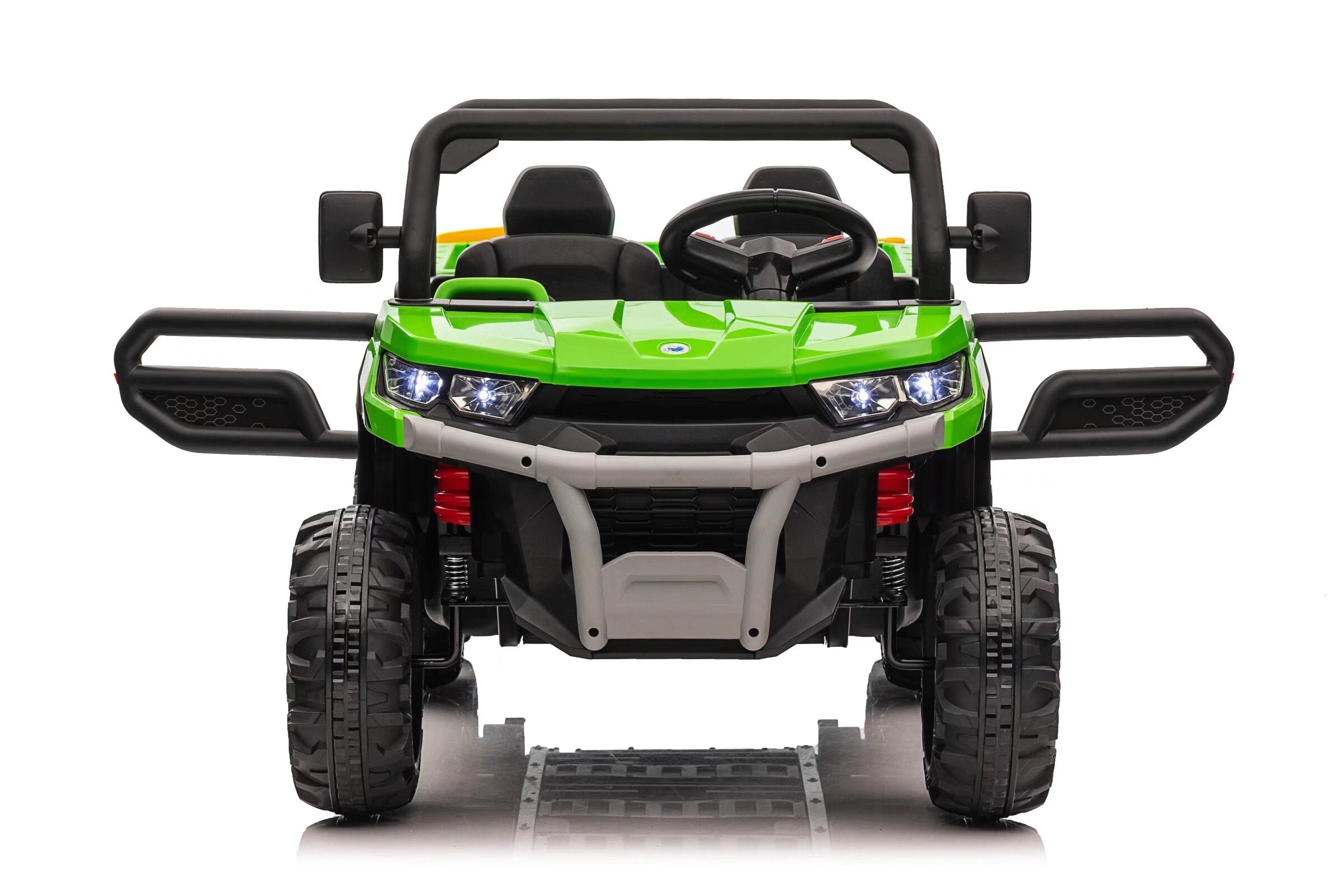 Front view of green 24V electric ride-on dump truck for kids with dual seats and open doors on a white background