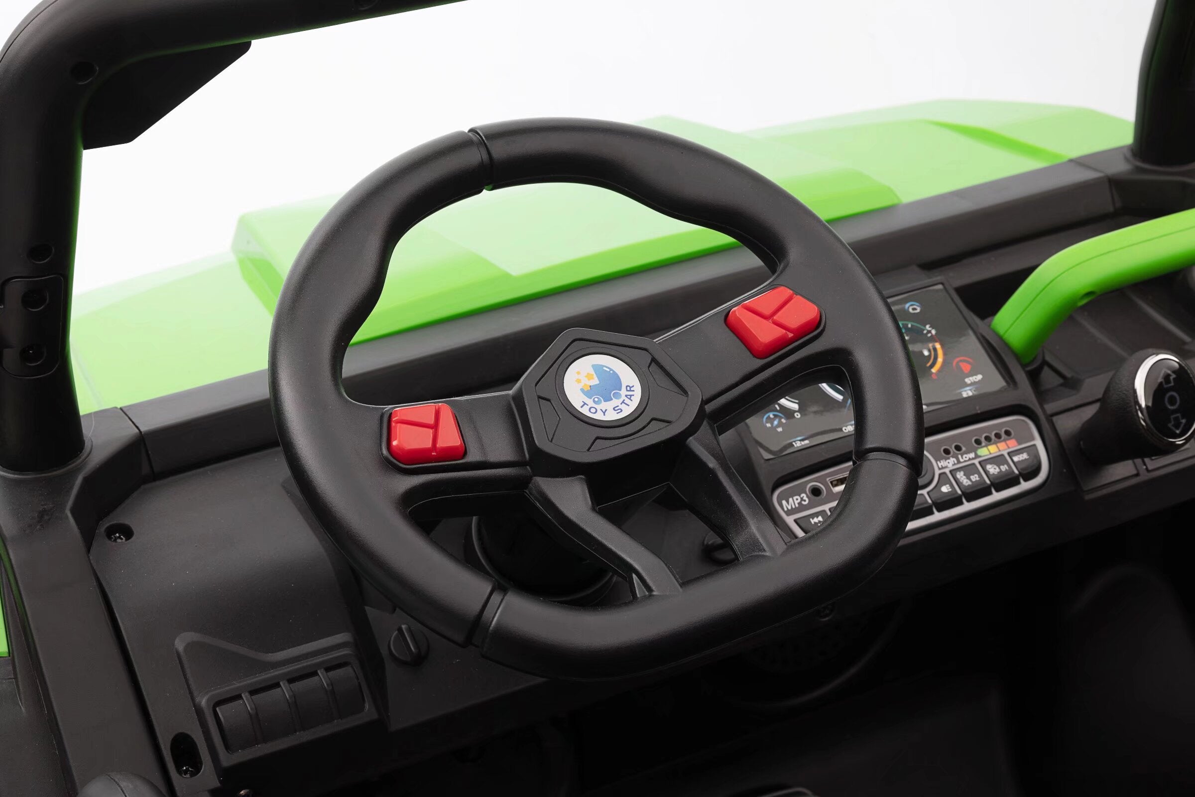 Close-up of the black steering wheel with red buttons on a green 24V electric ride-on dump truck for kids.
