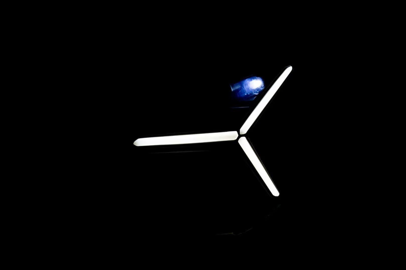 Black Lamborghini Revuelto 12V electric ride-on car for kids with LED headlights, shown in dim lighting.