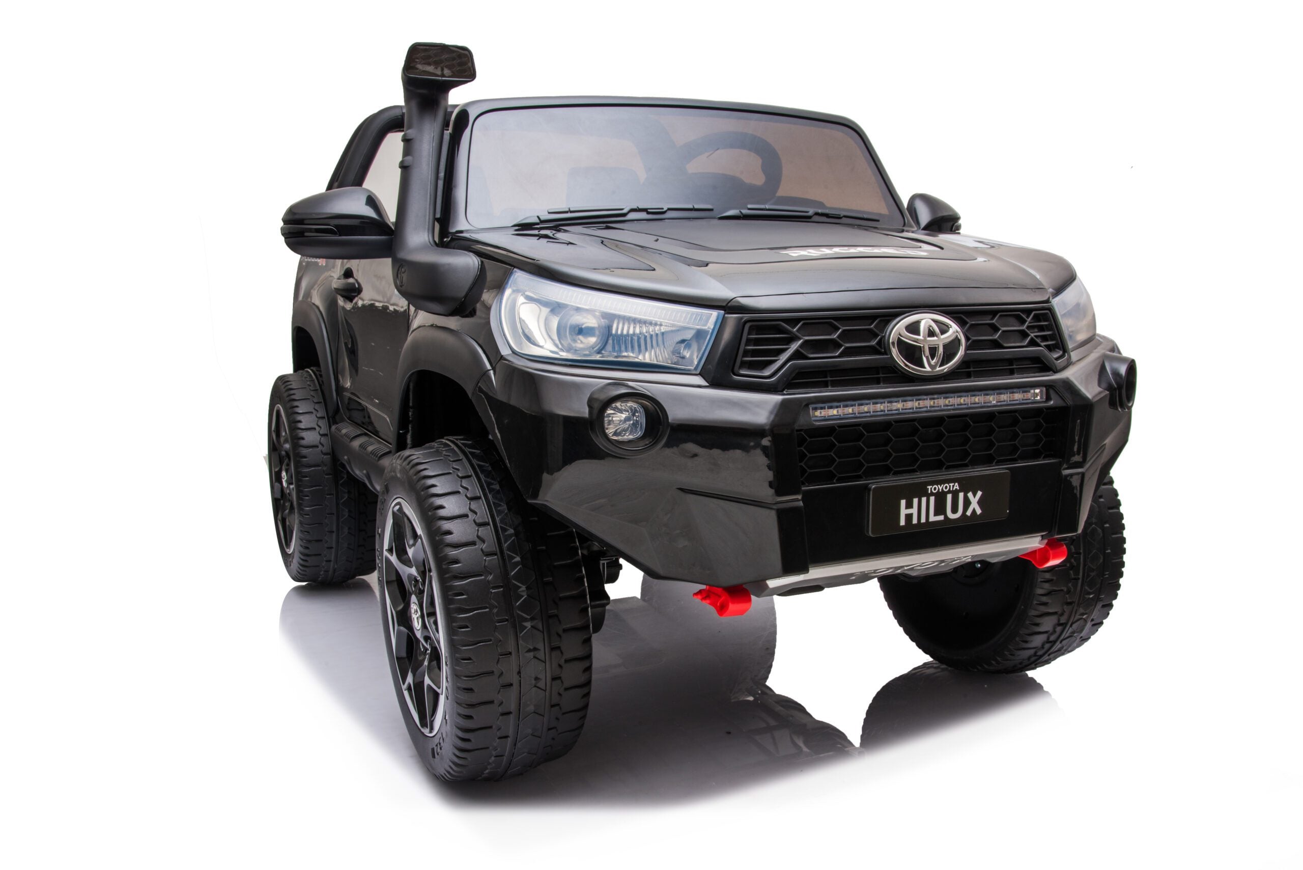 Black 24V Toyota Hilux 4WD ride-on electric car for kids with realistic details and LED headlights.