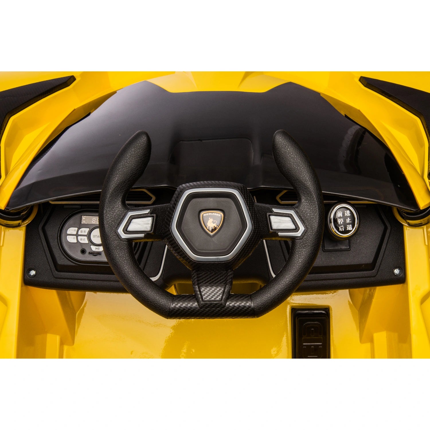 Close-up of black steering wheel with Lamborghini logo and control buttons on yellow 12V kids electric ride-on car