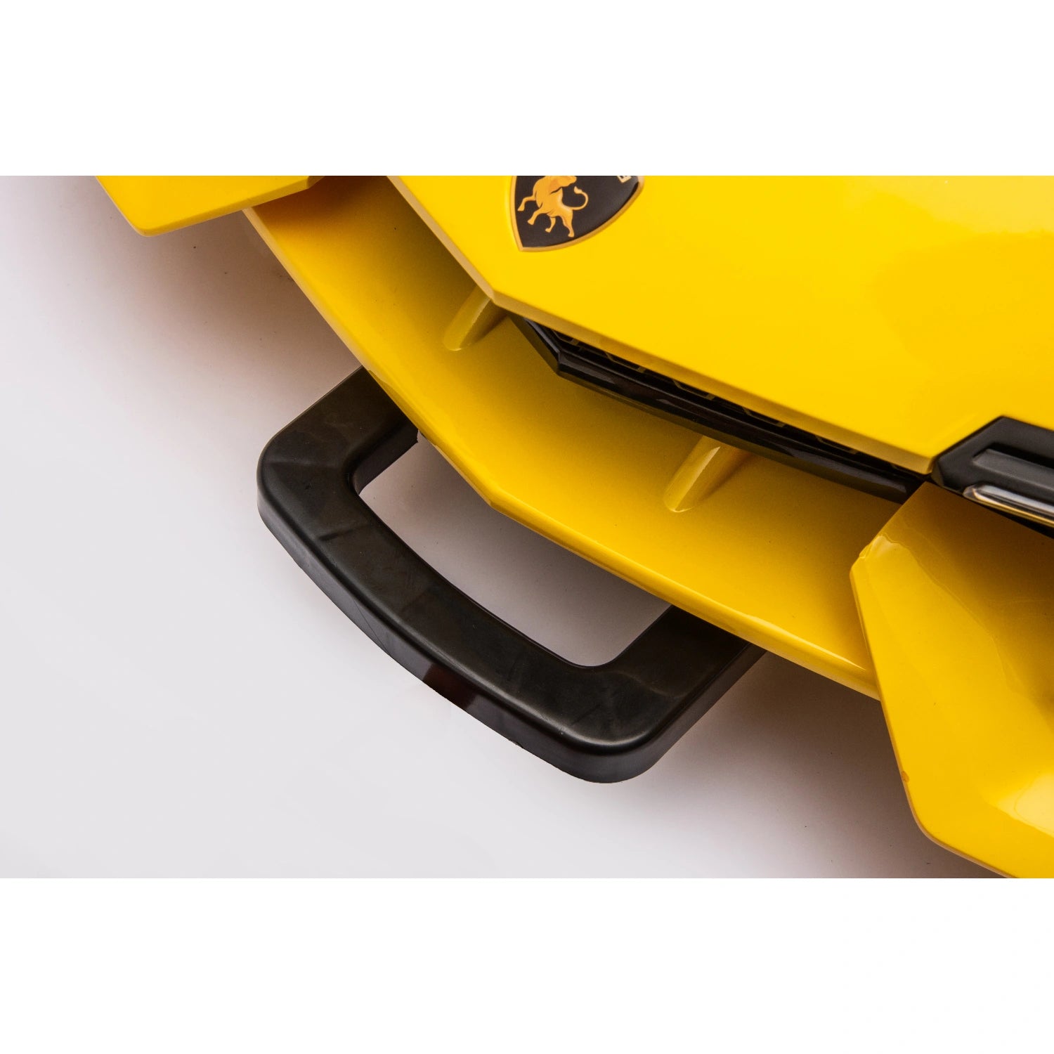Close-up of black front towing handle on yellow 12V Lamborghini inspired kids ride-on electric car.