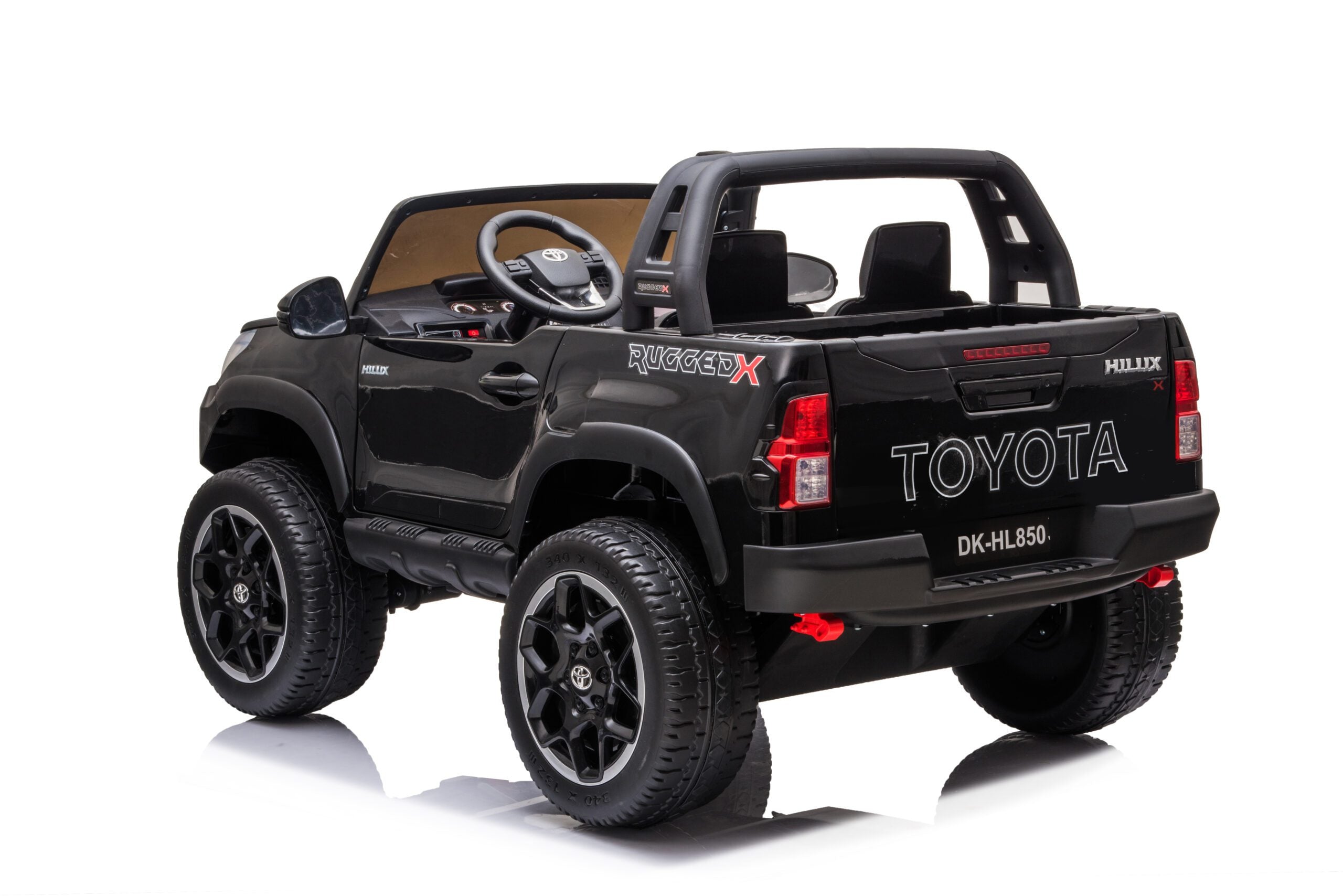Black 24V Toyota Hilux 4WD ride-on car for kids with realistic details, twin leather seats, and LED headlights.