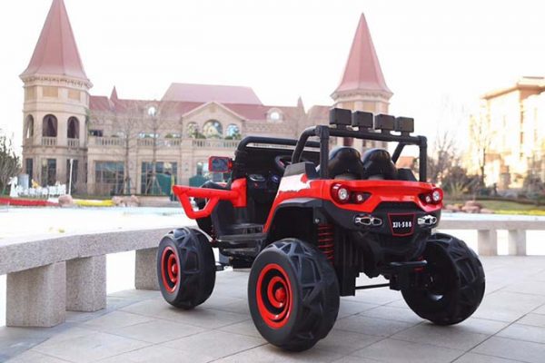 Red and black 12V 4WD monster truck ride-on buggy for kids with large off-road tires and suspension system.