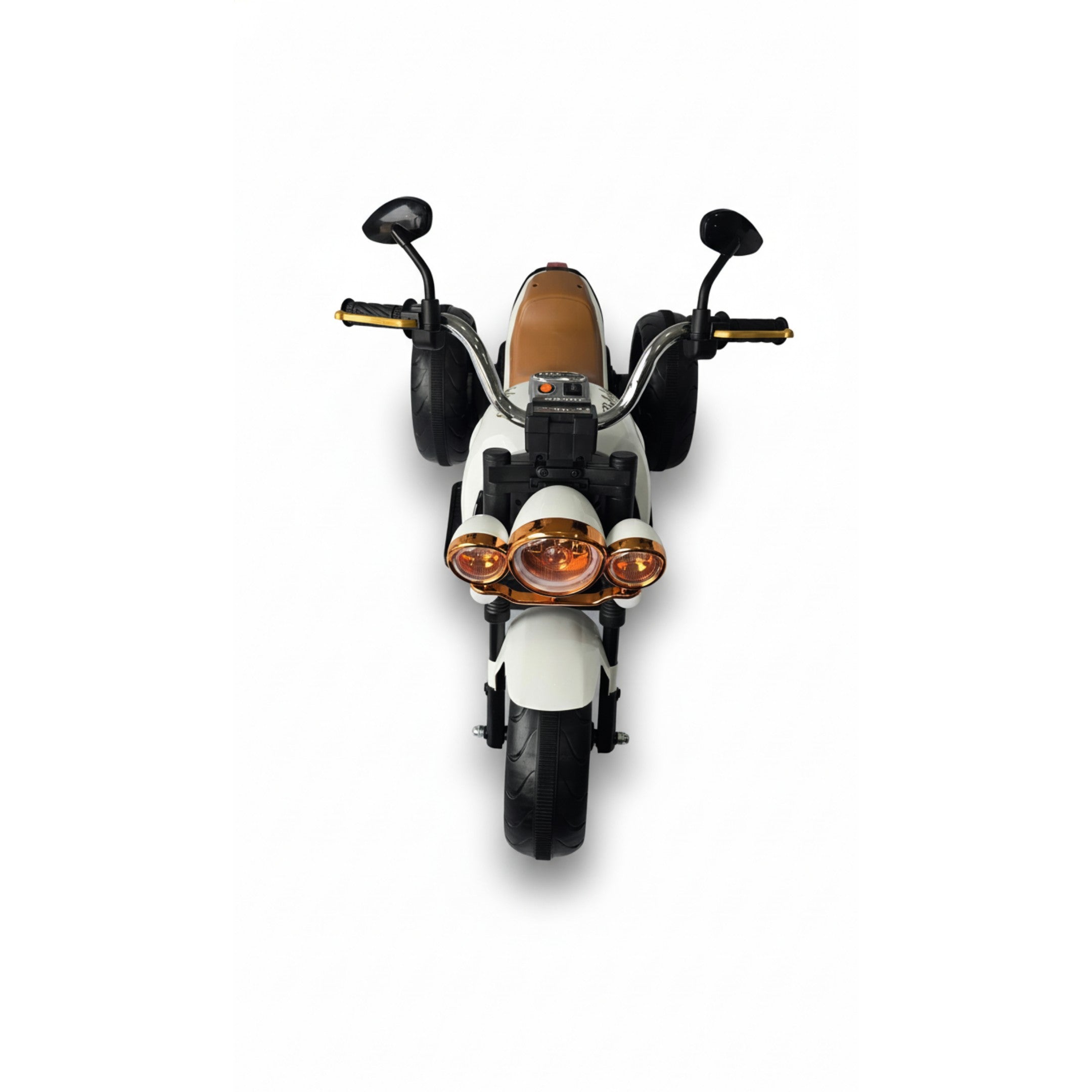 Front view of white 12V Harley-style kids electric motorbike with three wheels and amber headlights