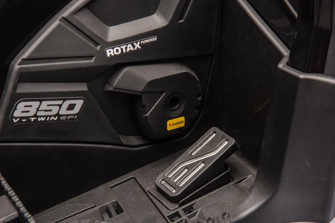 Close-up of black foot pedal and side panel with Rotax 850 V-Twin EFI logo on 24V licensed Can-Am Outlander quad bike