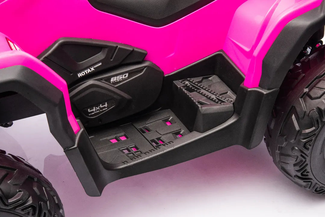 Close-up of pink Can-Am Outlander Monster 24V ride-on quad footrest and side panel with rugged black tires