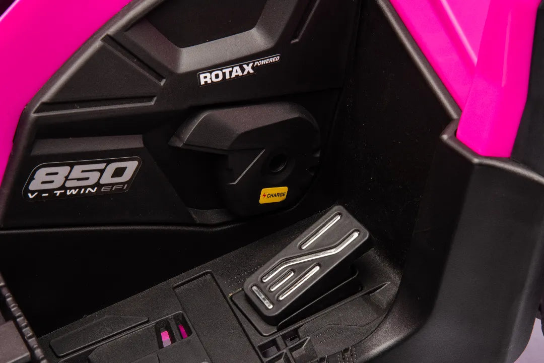 Close-up of black foot pedal and Rotax 850 V-Twin engine detail on Barbie pink 24V Can-Am Outlander ride-on quad.