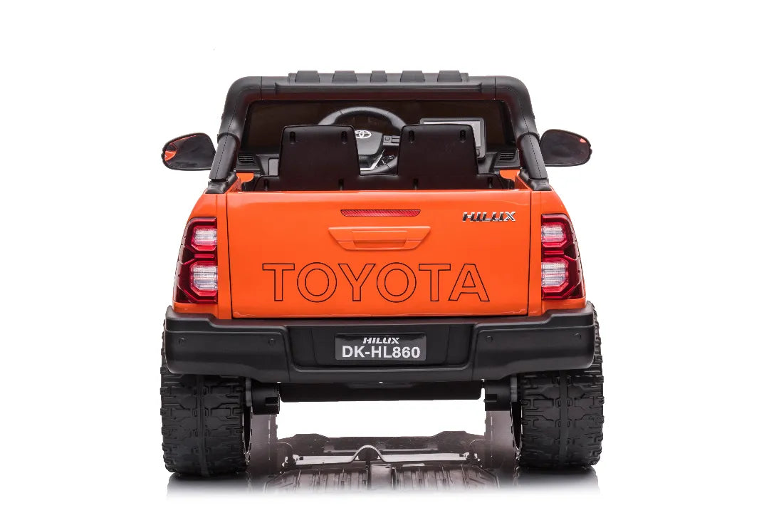 Rear view of orange 24V licensed Toyota Hilux SR5 2-seater kids ride-on ute with black seats and rugged tires